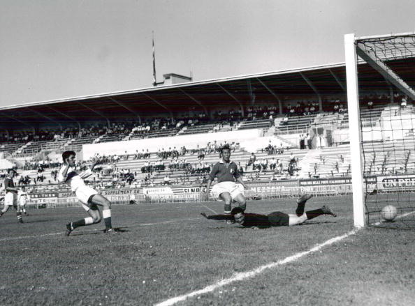 World Cup Finals, 1954, Geneva, Switzerland, 20th June, 1954, Turkey 7 v South Korea 0, Ismil Suat of Turkey (left) scores his side's third goal past South Korean goalkeeper Duk Yung Hong as defender Hung Chull Ham looks on  (Photo by Popperfoto/Getty Images)